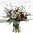 This Chislehurst-crafted bouquet is a tribute to the union of contrast and serenity, blending the passionate glow of crimson roses with the creamy calm of white gerberas and the misty elegance of pale lavender lisianthus. Wispy branches of eucalyptus arc outwards, their silvery-green leaves catching soft light, reminiscent of dappled shadows along Chislehurst's woodland trails. Fluffy white filler blooms gather in pearly clusters among lush, sculptural leaves that shine with a fresh, healthy gloss. Each element is anchored in a clear glass vase, where vibrant green stems soak in crisp water, promising lasting vitality. The subtle interplay of delicate floral fragrance and eucalyptus evokes both celebration and tenderness-whether commemorating personal milestones or simply extending a heartfelt gesture to someone along Chislehurst Lane. Composed by expert local florists, this arrangement captures both the gentle sophistication and rich heritage of the area, delivering emotion and artistry with each carefully selected stem.